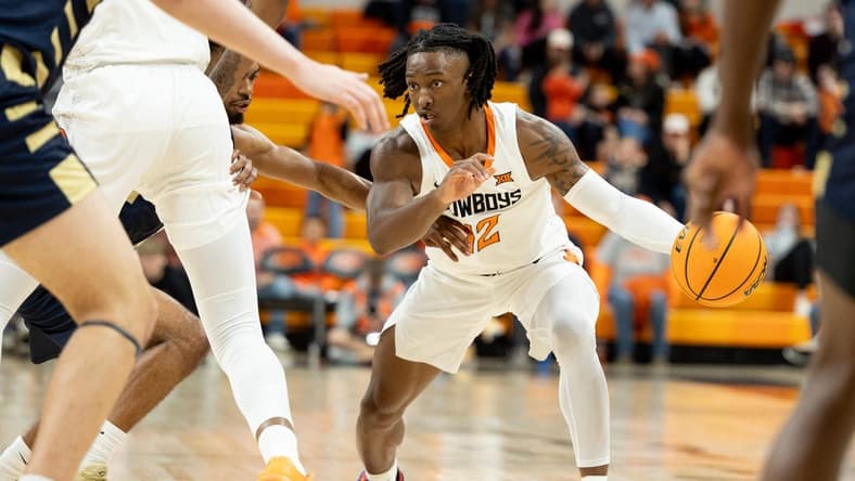 Dec 17, 2023; Stillwater, Okla, USA ; Oklahoma State Cowboys guard Javon Small (12) brings the ball up the court in the first half of an NCAA basketball game against the Oral Roberts Golden Eagles at Gallagher Iba arena. Mandatory Credit: Mitch Alcala-The Oklahoman