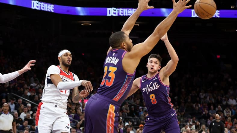 Dec 17, 2023; Phoenix, Arizona, USA; Phoenix Suns guard Eric Gordon (23) gets a steel from Washington Wizards center Daniel Gafford (21) during the first quarter at Footprint Center. Mandatory Credit: Zachary BonDurant-USA TODAY Sports