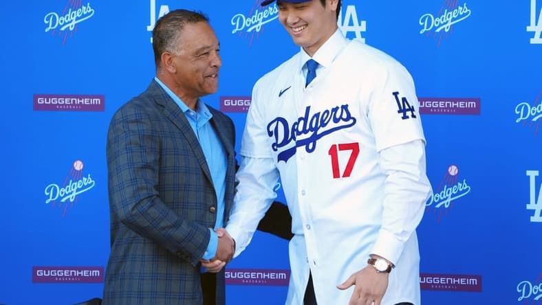 Dec 14, 2023; Los Angeles, CA, USA; Los Angeles Dodgers designated hitter Shohei Ohtani (17) shakes hands with manager Dave Roberts at press conference at Dodger Stadium. Mandatory Credit: Kirby Lee-USA TODAY Sports