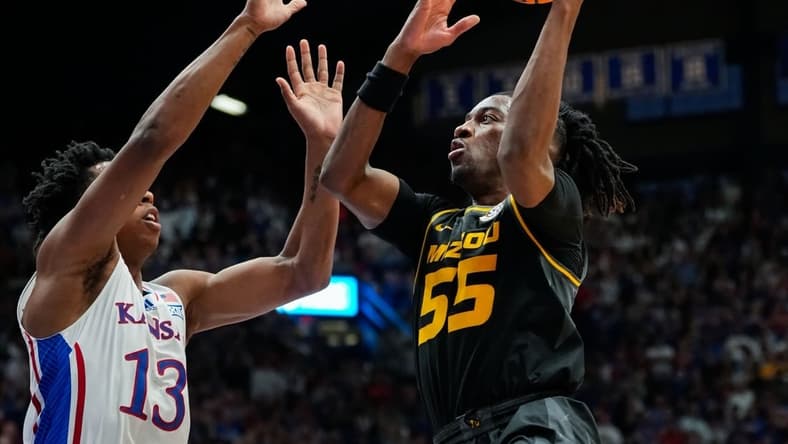 Dec 9, 2023; Lawrence, Kansas, USA; Missouri Tigers guard Sean East II (55) shoots against Kansas Jayhawks guard Elmarko Jackson (13) during the first half at Allen Fieldhouse. Mandatory Credit: Jay Biggerstaff-USA TODAY Sports