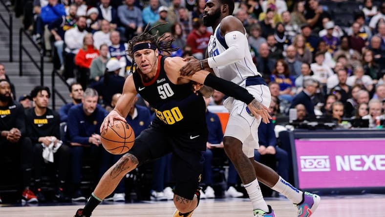 Dec 18, 2023; Denver, Colorado, USA; Denver Nuggets forward Aaron Gordon (50) controls the ball as Dallas Mavericks forward Tim Hardaway Jr. (10) guards in the second quarter at Ball Arena. Mandatory Credit: Isaiah J. Downing-USA TODAY Sports