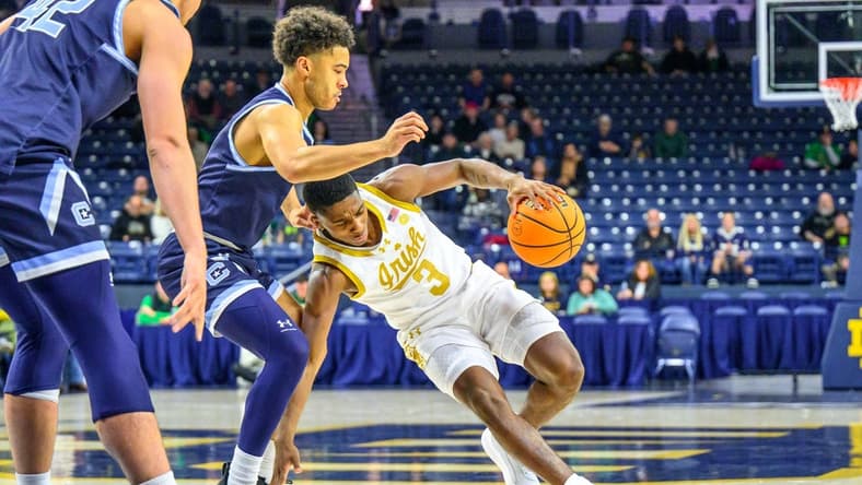 Dec 19, 2023; South Bend, Indiana, USA; Notre Dame Fighting Irish guard Markus Burton (3) loses his footing as Citadel Bulldogs guard Elijah Morgan (4) defends in the first half at the Purcell Pavilion. Mandatory Credit: Matt Cashore-USA TODAY Sports