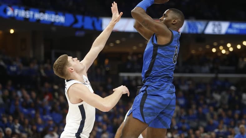 Dec 19, 2023; Memphis, Tennessee, USA; Memphis Tigers forward David Jones (8) shoots as Virginia Cavaliers guard Isaac McKneely (11) defends during the first half at FedExForum. Mandatory Credit: Petre Thomas-USA TODAY Sports