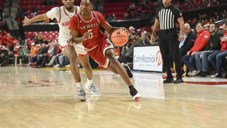 Dec 19, 2023; College Park, Maryland, USA; Nicholls State Colonels forward Diante Smith (5) dribble by Maryland Terrapins guard Jahari Long (2) during the first half at Xfinity Center. Mandatory Credit: Tommy Gilligan-USA TODAY Sports