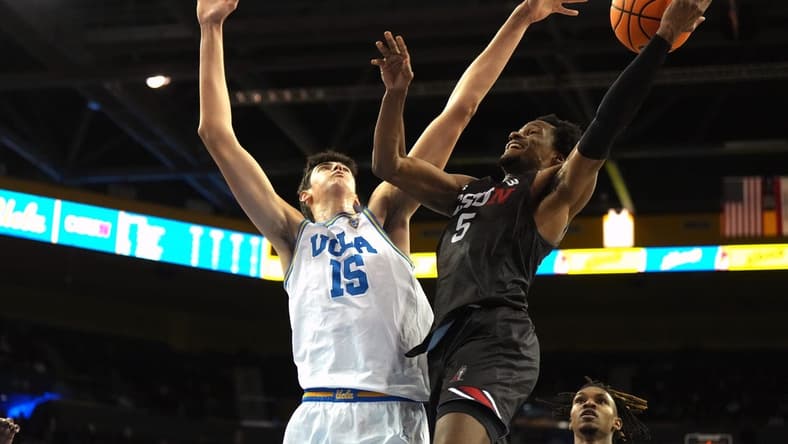 Dec 19, 2023; Los Angeles, California, USA; Cal State Northridge Matadors guard Gianni Hunt (5) shoots against UCLA Bruins center Aday Mara (15) in the first half at Pauley Pavilion presented by Wescom. Mandatory Credit: Kirby Lee-USA TODAY Sports