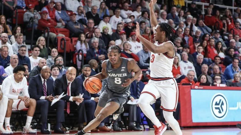 Dec 20, 2023; Queens, New York, USA; Xavier Musketeers guard Quincy Olivari (8) looks to drive past St. John's Red Storm guard Jordan Dingle (3) in the first half at Carnesecca Arena. Mandatory Credit: Wendell Cruz-USA TODAY Sports