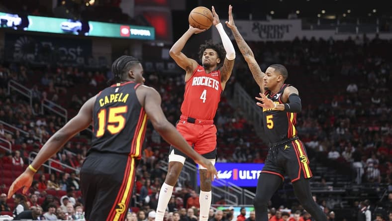 Dec 20, 2023; Houston, Texas, USA; Houston Rockets guard Jalen Green (4) shoots the ball as Atlanta Hawks guard Dejounte Murray (5) defends during the first quarter at Toyota Center. Mandatory Credit: Troy Taormina-USA TODAY Sports