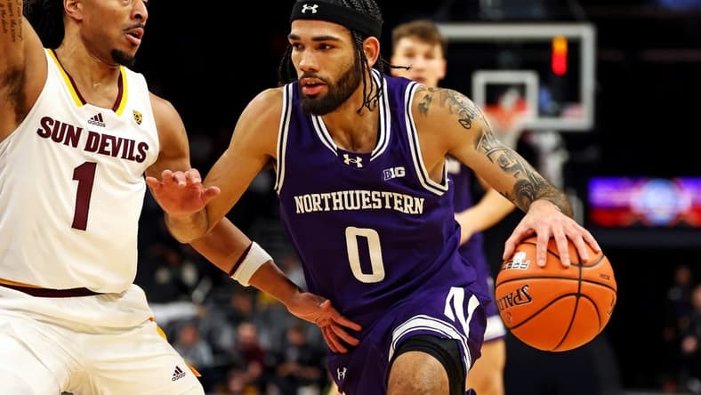 Dec 20, 2023; Phoenix, Arizona, USA; Northwestern Wildcats guard Boo Buie (0) drives to the basket against Arizona State Sun Devils guard Frankie Collins (1) during the first half during the Hall of Series at Footprint Center. Mandatory Credit: Mark J. Rebilas-USA TODAY Sports