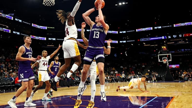 Dec 20, 2023; Phoenix, Arizona, USA; Northwestern Wildcats guard Brooks Barnhizer (13) shoots the ball against Arizona State Sun Devils forward Bryant Selebangue (24) during the first half during the Hall of Series at Footprint Center. Mandatory Credit: Mark J. Rebilas-USA TODAY Sports