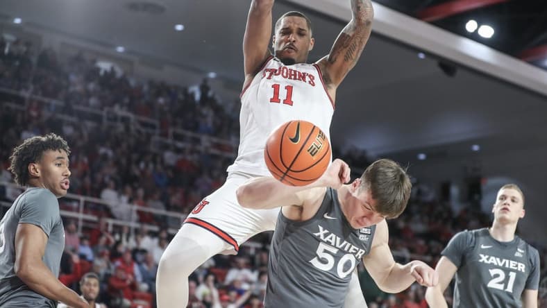 Dec 20, 2023; Queens, New York, USA; St. John's Red Storm center Joel Soriano (11) dunks over Xavier Musketeers forward Gytis Nemeiksa (50) in the second half at Carnesecca Arena. Mandatory Credit: Wendell Cruz-USA TODAY Sports
