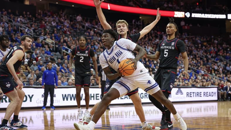 Dec 20, 2023; Newark, New Jersey, USA; Seton Hall Pirates guard Kadary Richmond (1) drives to the basket in front of Connecticut Huskies guard Cam Spencer (12) and guard Stephon Castle (5) during the second half at Prudential Center. Mandatory Credit: Vincent Carchietta-USA TODAY Sports
