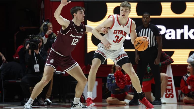 Dec 20, 2023; Salt Lake City, Utah, USA; Utah Utes center Lawson Lovering (34) posts up against Bellarmine Knights forward Langdon Hatton (12) during the first half at Jon M. Huntsman Center. Mandatory Credit: Rob Gray-USA TODAY Sports