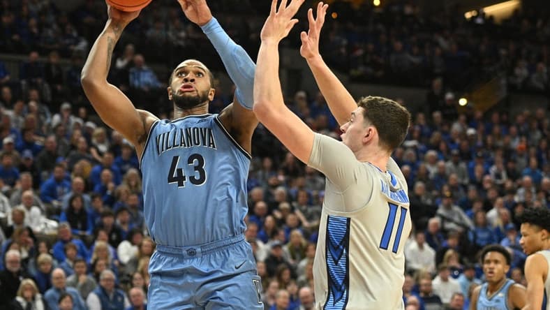 Dec 20, 2023; Omaha, Nebraska, USA; Villanova Wildcats forward Eric Dixon (43) scores against Creighton Bluejays center Ryan Kalkbrenner (11) in the first half at CHI Health Center Omaha. Mandatory Credit: Steven Branscombe-USA TODAY Sports