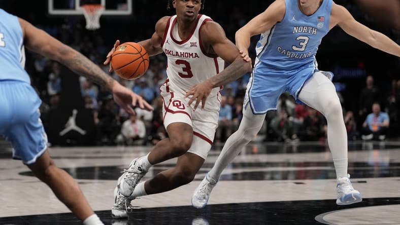 Dec 20, 2023; Charlotte, North Carolina, USA; Oklahoma Sooners guard Otega Oweh (3) drives to the basket against North Carolina Tar Heels guard Cormac Ryan (3) during the first half at Spectrum Center. Mandatory Credit: Jim Dedmon-USA TODAY Sports