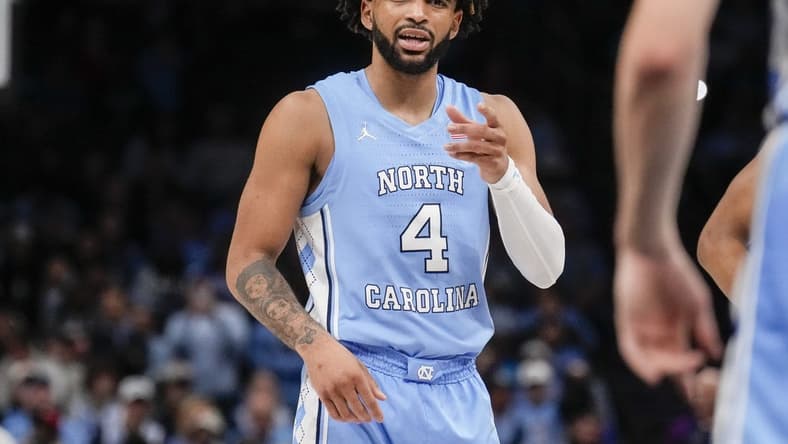 Dec 20, 2023; Charlotte, North Carolina, USA; North Carolina Tar Heels guard RJ Davis (4) talks to a teammate during a foul shot against the Oklahoma Sooners during the second half at Spectrum Center. Mandatory Credit: Jim Dedmon-USA TODAY Sports