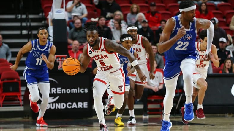 Dec 21, 2023; Lubbock, Texas, USA; Texas Tech Red Raiders guard Joe Toussaint (6) brings the ball up court against Texas-Arlington Mavericks forward Shemar Wilson (22) and forward Dwayne Korma (11) in the first half at United Supermarkets Arena. Mandatory Credit: Michael C. Johnson-USA TODAY Sports