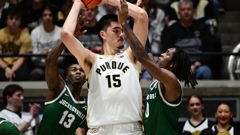 Dec 21, 2023; West Lafayette, Indiana, USA;  Purdue Boilermakers center Zach Edey (15) keeps the ball away from Jacksonville Dolphins guard Robert McCray V (13) and forward Stephon Payne III (0) right, during the first half at Mackey Arena. Mandatory Credit: Marc Lebryk-USA TODAY Sports