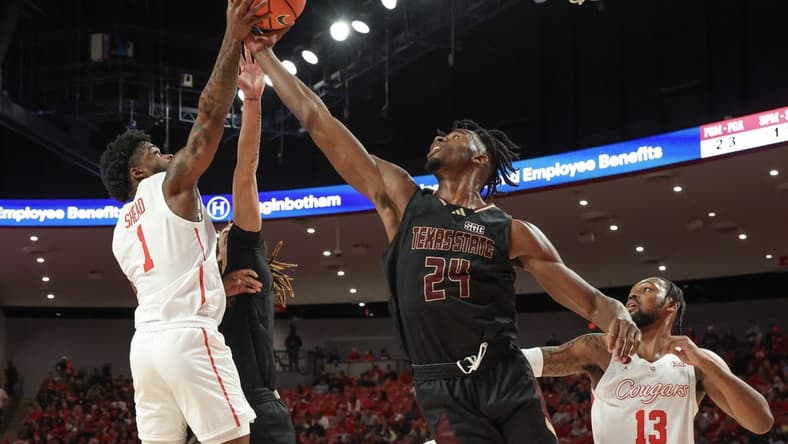 Dec 21, 2023; Houston, Texas, USA; Houston Cougars guard Jamal Shead (1) grabs defensive rebound against Texas State Bobcats forward Brandon Love (24) in the first half at Fertitta Center. Mandatory Credit: Thomas Shea-USA TODAY Sports