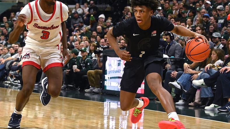 Dec 21, 2023; East Lansing, Michigan, USA; Michigan State Spartans guard Jeremy Fears Jr. (1) drives past Stony Brook Seawolves guard Toby Onyekonwu (3) during the second half at Jack Breslin Student Events Center. Mandatory Credit: Dale Young-USA TODAY Sports
