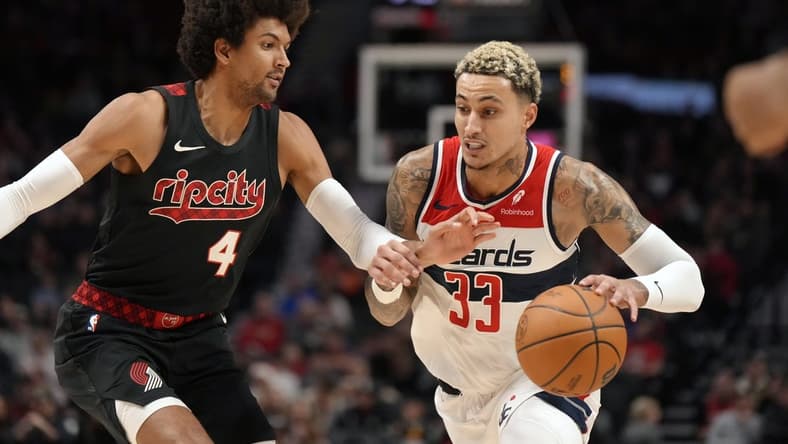 Dec 21, 2023; Portland, Oregon, USA; Washington Wizards small forward Kyle Kuzma (33) dribbles the ball as Portland Trail Blazers shooting guard Matisse Thybulle (4) defends during the first half at Moda Center. Mandatory Credit: Soobum Im-USA TODAY Sports