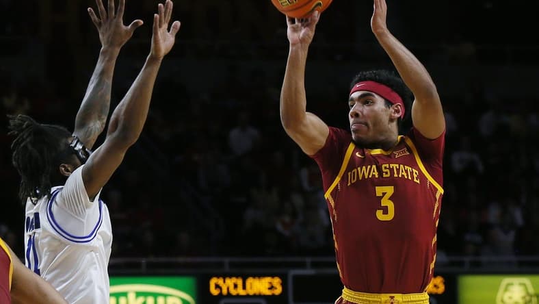 Iowa State Cyclones guard Tamin Lipsey (3) takes athree-pont shot over Eastern Illinois Panthers guard Jordan Booker (11) during the first half of a NCAA college basketball at Hilton Coliseum on Thursday, Dec. 21, 2023, in Ames, Iowa.