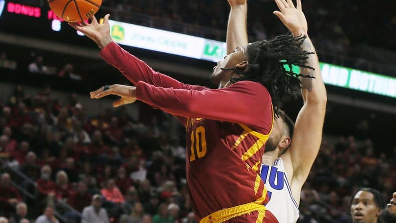 Iowa State Cyclones guard Keshon Gilbert (10) lays up the ball around Eastern Illinois Panthers forward Lazar Grbovic (17)during the first half of a NCAA college basketball at Hilton Coliseum on Thursday, Dec. 21, 2023, in Ames, Iowa.