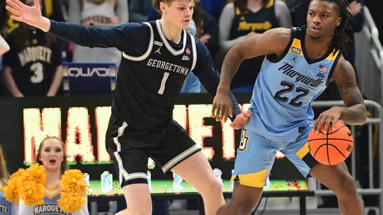 Dec 22, 2023; Milwaukee, Wisconsin, USA; Marquette Golden Eagles guard Sean Jones (22) is guarded by Georgetown Hoyas guard Rowan Brumbaugh (1) in the first half at Fiserv Forum. Mandatory Credit: Benny Sieu-USA TODAY Sports