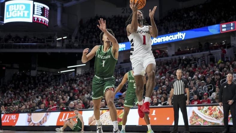 Dec 22, 2023; Cincinnati, Ohio, USA; Cincinnati Bearcats forward Day Day Thomas (1) drives to the basket against Stetson Hatters guard Tristan Gross (1) in the first half at Fifth Third Arena. Mandatory Credit: Aaron Doster-USA TODAY Sports