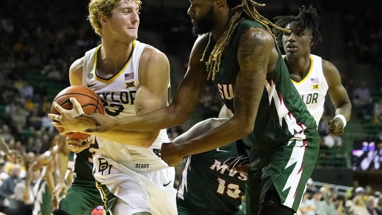 Dec 22, 2023; Waco, Texas, USA; Baylor Bears forward Caleb Lohner (33) grabs the ball from Mississippi Valley State Delta Devils guard Arecko Gipson (23) at Ferrell Center. Mandatory Credit: Raymond Carlin III-USA TODAY Sports
