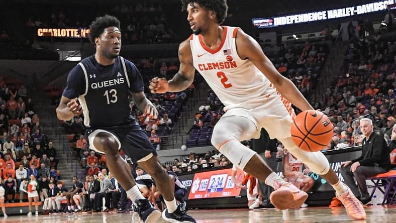 Dec 22, 2023; Clemson, South Carolina, USA; Clemson sophomore guard Dillon Hunter (2) dribbles near Queens University guard Dayton Albury (13) during the second half at Littlejohn Coliseum. Mandatory Credit: Ken Ruinard-USA TODAY Sports