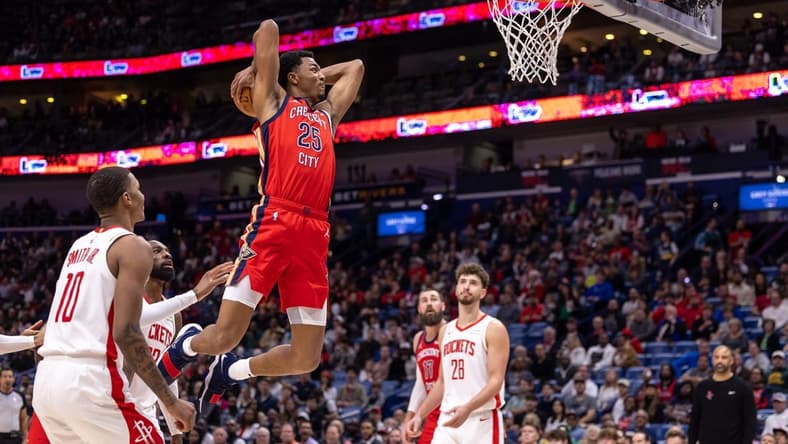 Dec 23, 2023; New Orleans, Louisiana, USA; New Orleans Pelicans guard Trey Murphy III (25) dunks against Houston Rockets forward Jabari Smith Jr. (10) during the first half at Smoothie King Center. Mandatory Credit: Stephen Lew-USA TODAY Sports