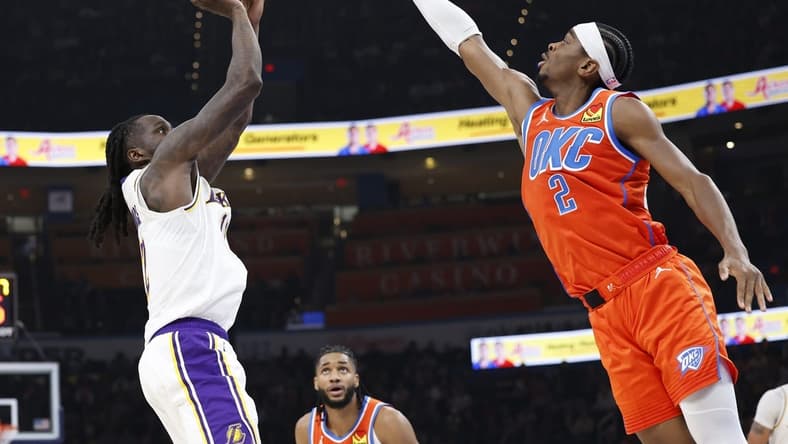 Dec 23, 2023; Oklahoma City, Oklahoma, USA; Los Angeles Lakers forward Taurean Prince (12) shoots as Oklahoma City Thunder guard Shai Gilgeous-Alexander (2) defends during the second quarter at Paycom Center. Mandatory Credit: Alonzo Adams-USA TODAY Sports