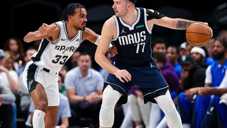 Dec 23, 2023; Dallas, Texas, USA; Dallas Mavericks guard Luka Doncic (77) controls the ball as San Antonio Spurs guard Tre Jones (33) defends during the second quarter at American Airlines Center. Mandatory Credit: Kevin Jairaj-USA TODAY Sports