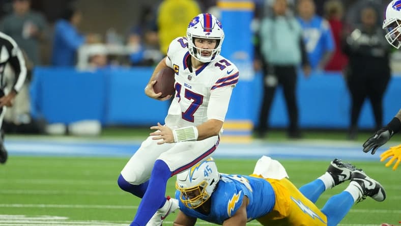 Dec 23, 2023; Inglewood, California, USA; Buffalo Bills quarterback Josh Allen (17) carries the ball against Los Angeles Chargers linebacker Tuli Tuipulotu (45) in the first half at SoFi Stadium. Mandatory Credit: Kirby Lee-USA TODAY Sports
