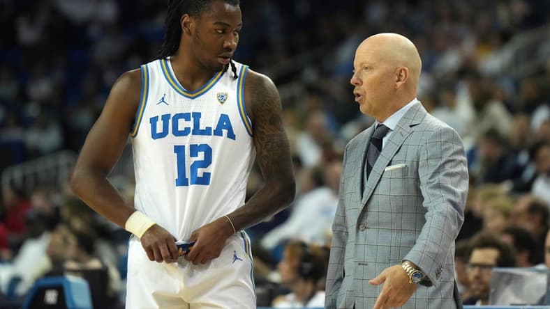 Dec 22, 2023; Los Angeles, California, USA; UCLA Bruins head coach MIck Cronin (right) talks with guard Sebastian Mack (12) against the Maryland Terrapins in the second half at Pauley Pavilion presented by Wescom. Mandatory Credit: Kirby Lee-USA TODAY Sports