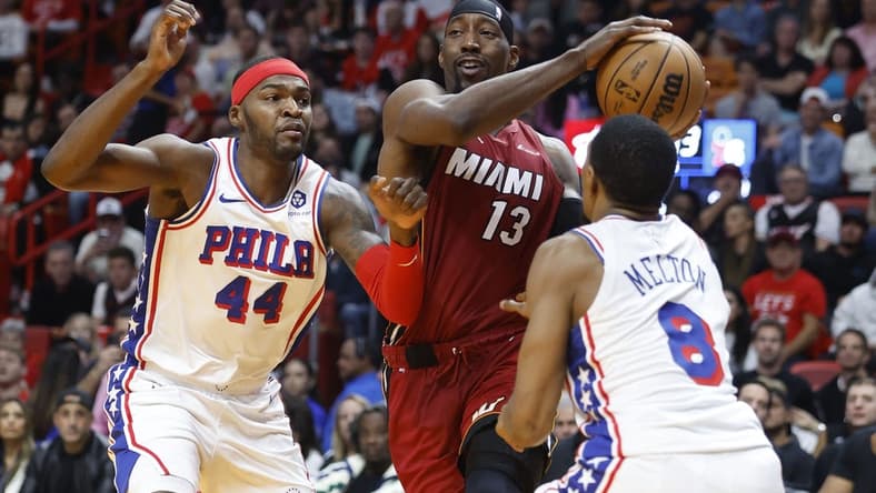 Dec 25, 2023; Miami, Florida, USA; Philadelphia 76ers forward Paul Reed (44) and  guard De'Anthony Melton (8) defend Miami Heat center Bam Adebayo (13) during the first half at Kaseya Center. Mandatory Credit: Rhona Wise-USA TODAY Sports