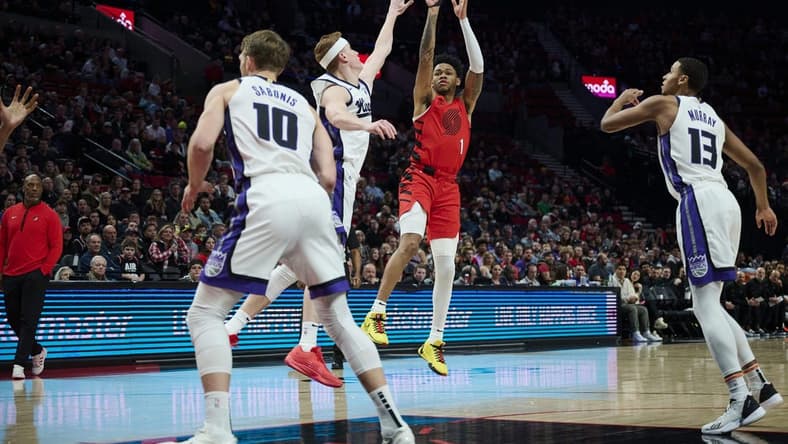 Dec 26, 2023; Portland, Oregon, USA; Portland Trail Blazers guard Anfernee Simons (1) shoots a jump shot against Sacramento Kings guard Kevin Huerter (9) during the first half at Moda Center. Mandatory Credit: Troy Wayrynen-USA TODAY Sports