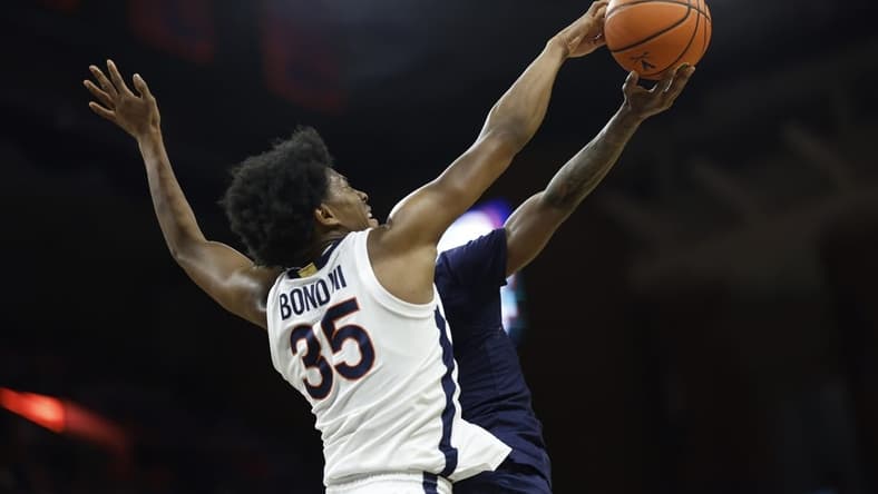 Dec 27, 2023; Charlottesville, Virginia, USA; Virginia Cavaliers guard Leon Bond III (35) blocks the shot of Morgan State Bears guard Rob Lawson (3) in the first half at John Paul Jones Arena. Mandatory Credit: Geoff Burke-USA TODAY Sports