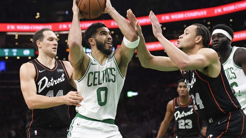 Dec 28, 2023; Boston, Massachusetts, USA; Boston Celtics forward Jayson Tatum (0) drives to the basket while Detroit Pistons forward Kevin Knox II (24) defends during the first half at TD Garden. Mandatory Credit: Bob DeChiara-USA TODAY Sports