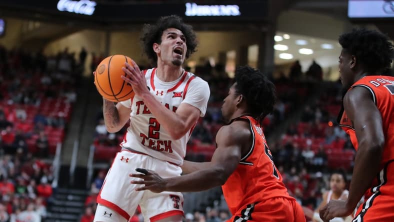 Dec 28, 2023; Lubbock, Texas, USA; Texas Tech Red Raiders guard Pop Isaacs (2) shoots over Sam Houston Bearkats guard Marcus Boykin (5) in the first half at United Supermarkets Arena. Mandatory Credit: Michael C. Johnson-USA TODAY Sports