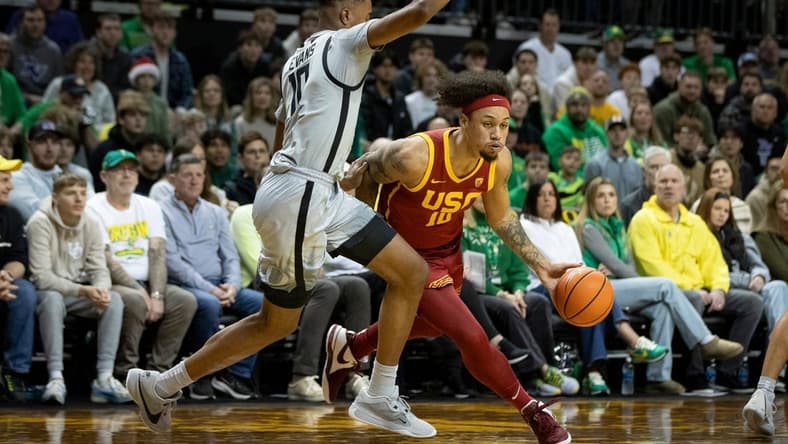 USC forward DJ Rodman drives toward the basket under cover from Oregon guard Kwame Evans Jr. as the Oregon Ducks host the USC Trojans Thursday, Dec. 28, 2023, at Matthew Knight Arena in Eugene, Ore.