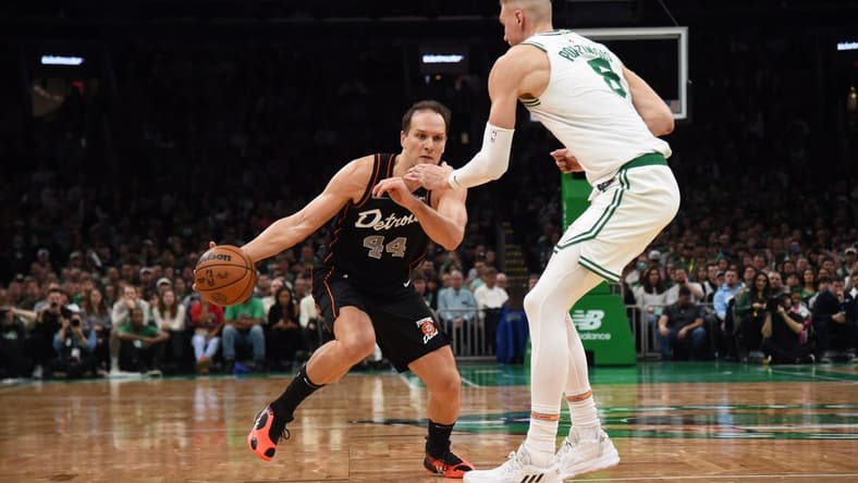 Dec 28, 2023; Boston, Massachusetts, USA; Detroit Pistons forward Bojan Bogdanovic (44) controls the ball while Boston Celtics center Kristaps Porzingis (8) defends during the second half at TD Garden. Mandatory Credit: Bob DeChiara-USA TODAY Sports