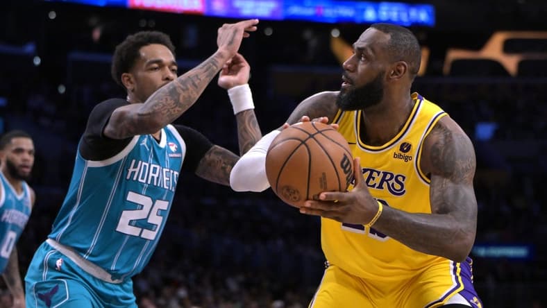 Dec 28, 2023; Los Angeles, California, USA; Charlotte Hornets forward P.J. Washington (25) defends Los Angeles Lakers forward LeBron James (23) in the first half at Crypto.com Arena. Mandatory Credit: Jayne Kamin-Oncea-USA TODAY Sports
