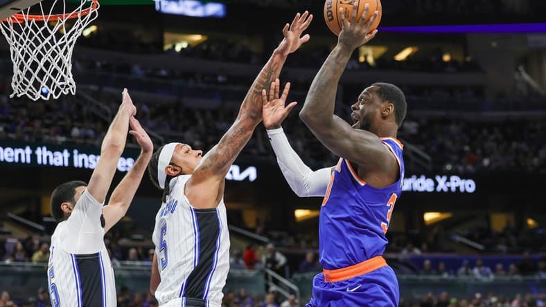 Dec 29, 2023; Orlando, Florida, USA; New York Knicks forward Julius Randle (30) shoots against Orlando Magic forward Paolo Banchero (5) during the first quarter at KIA Center. Mandatory Credit: Mike Watters-USA TODAY Sports