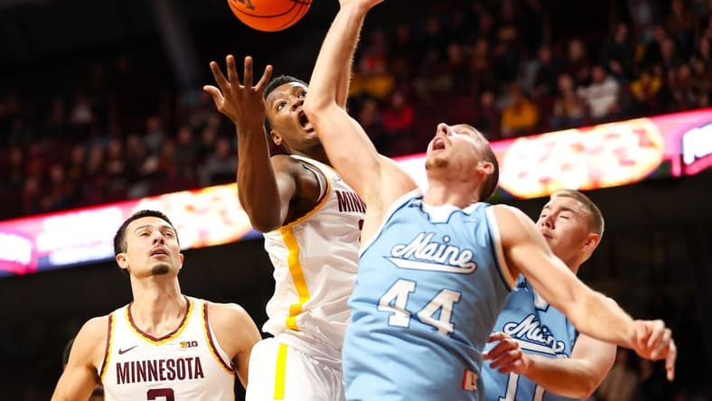 Dec 29, 2023; Minneapolis, Minnesota, USA; Minnesota Golden Gophers forward Pharrel Payne (21) and Maine Black Bears forward Peter Filipovity (44) jump for a rebound during the first half at Williams Arena. Mandatory Credit: Matt Krohn-USA TODAY Sports