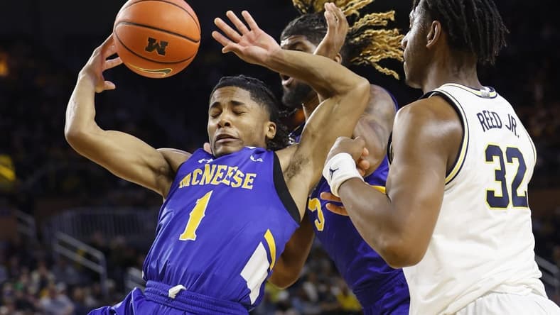 Dec 29, 2023; Ann Arbor, Michigan, USA; m1 go for the rebound in the first half over Michigan Wolverines forward Tarris Reed Jr. (32) in the first half at Crisler Center. Mandatory Credit: Rick Osentoski-USA TODAY Sports