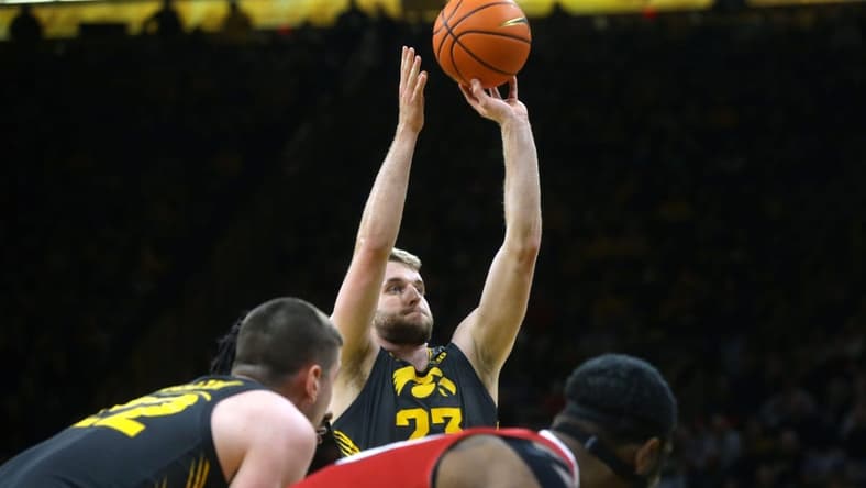 Iowa's Ben Krikke (23) attempts a free throw against Northern Illinois Friday, Dec. 29, 2023 at Carver-Hawkeye Arena in Iowa City, Iowa.