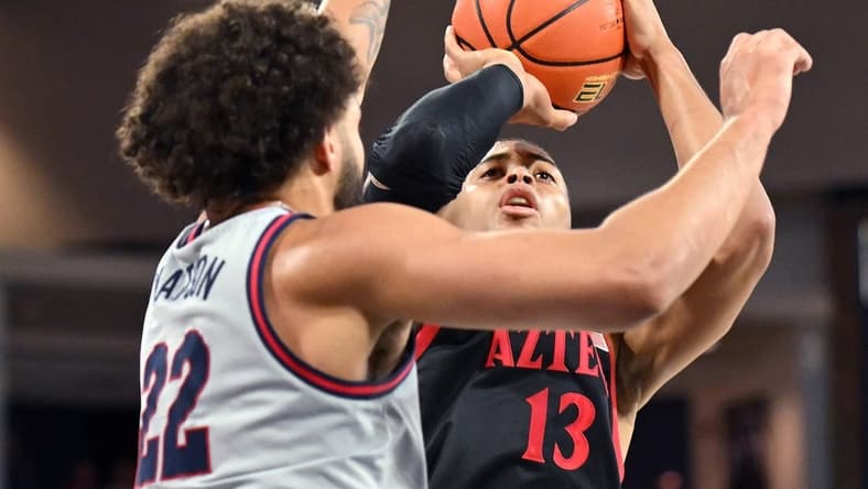 Dec 29, 2023; Spokane, Washington, USA; San Diego State Aztecs forward Jaedon LeDee (13) shoots the ball against Gonzaga Bulldogs forward Anton Watson (22) in the first half at McCarthey Athletic Center. Mandatory Credit: James Snook-USA TODAY Sports