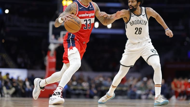 Dec 29, 2023; Washington, District of Columbia, USA; Washington Wizards forward Kyle Kuzma (33) dribbles the ball as Brooklyn Nets guard Spencer Dinwiddie (26) defends in the second quarter at Capital One Arena. Mandatory Credit: Geoff Burke-USA TODAY Sports