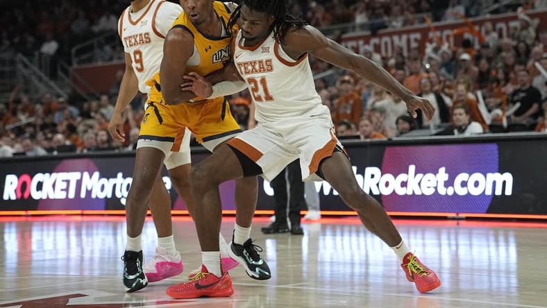 Dec 29, 2023; Austin, Texas, USA; Texas Longhorns forward Ze'Rik Onyema (21) boxes out UNC Greensboro Spartans forward Jalen Breath (22) during the second half at Moody Center. Mandatory Credit: Scott Wachter-USA TODAY Sports